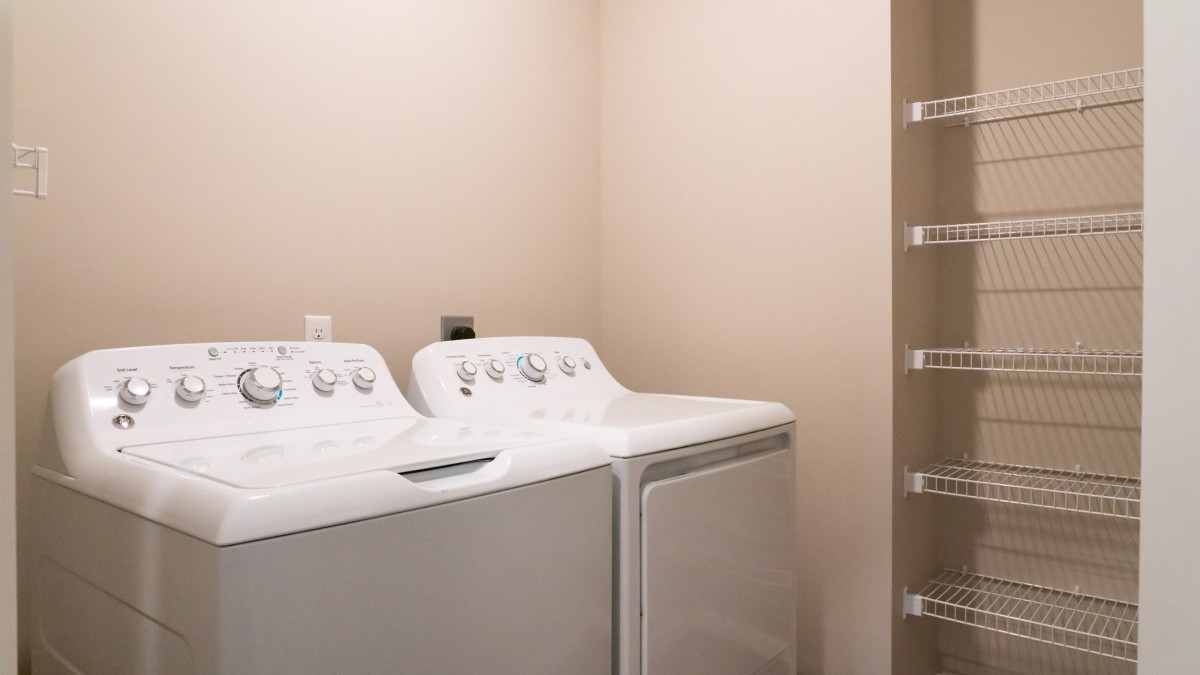 A laundry room with a washing machine and dryer ready for use.