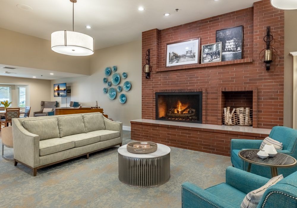 A cozy living room featuring a modern fireplace, comfortable seating, and stylish decor.