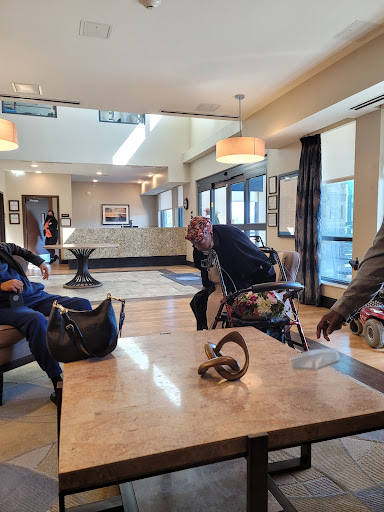 People enjoying their time in a modern hotel lobby.