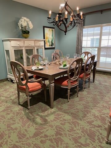 A neatly arranged dining room with a set table and elegant decor.
