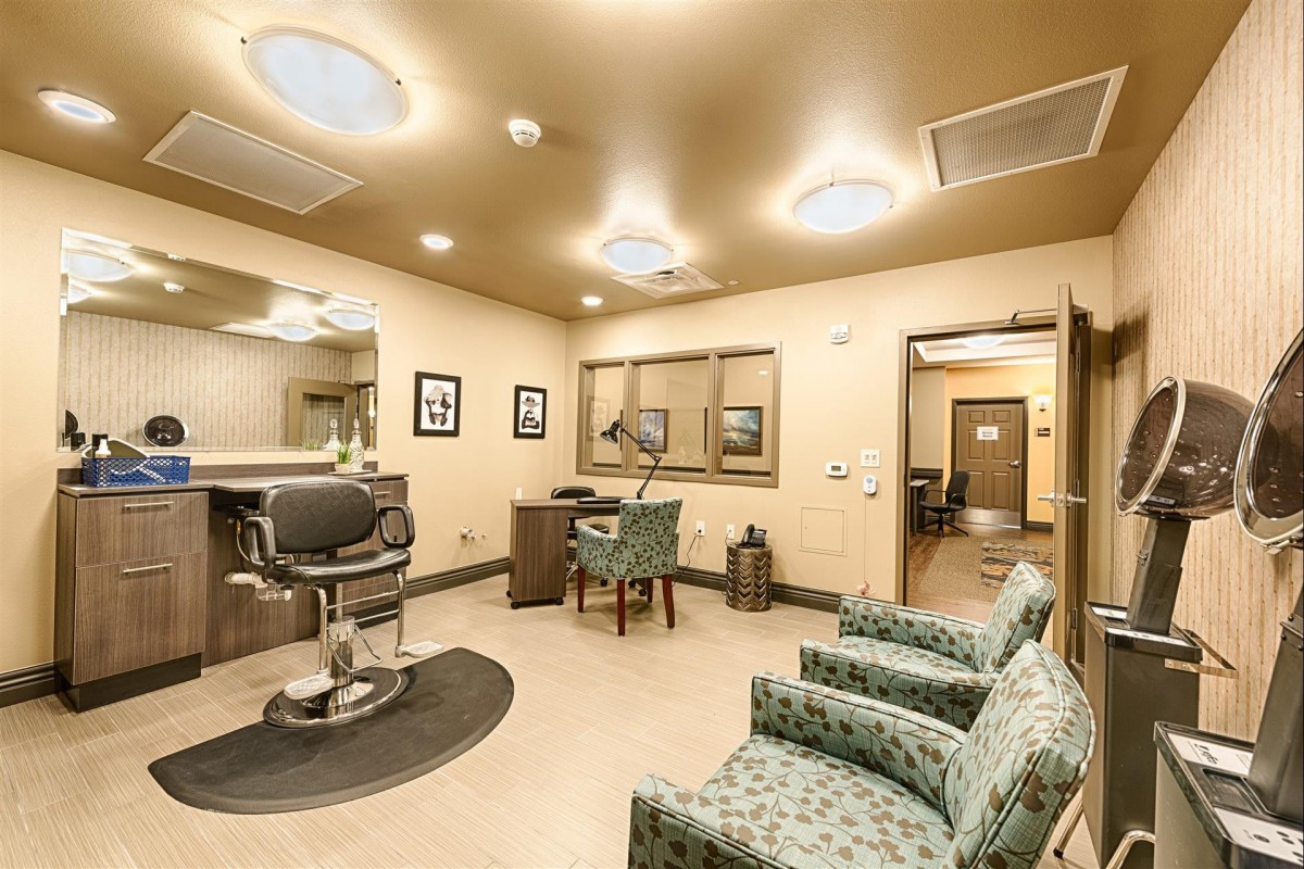 A modern barber shop interior with a stylish waiting area and a barber chair.