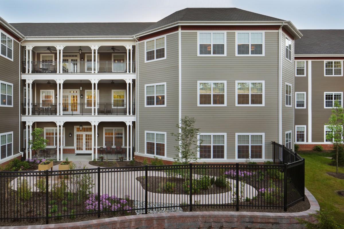 A modern apartment building with multiple balconies and well-maintained landscaping.
