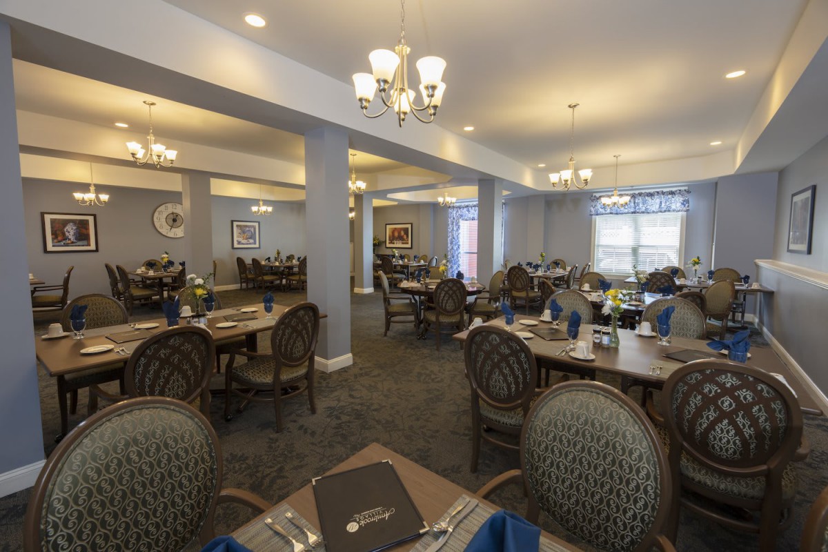 Elegant dining area with well-arranged tables and chandeliers.