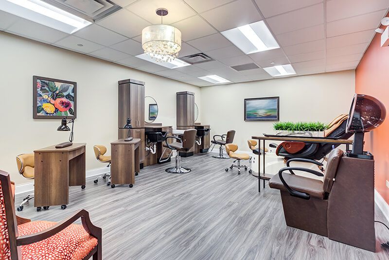A modern salon interior with stylish chairs and mirrors.