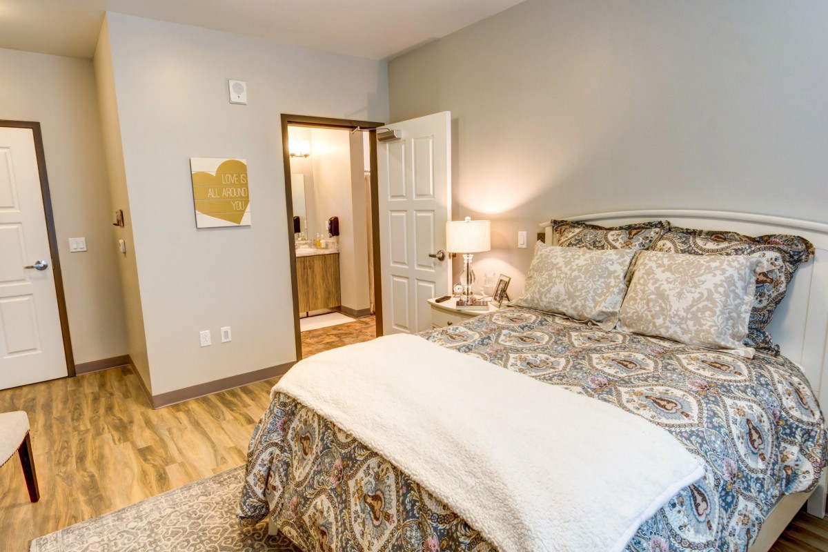 A cozy and modern bedroom with a neatly made bed and warm lighting.