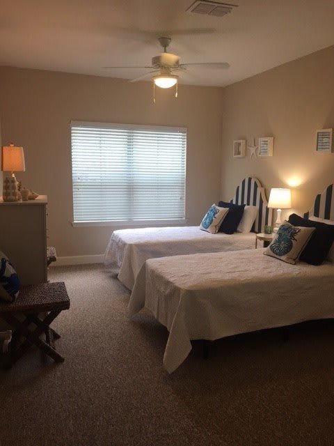 A cozy bedroom with twin beds and modern decor.