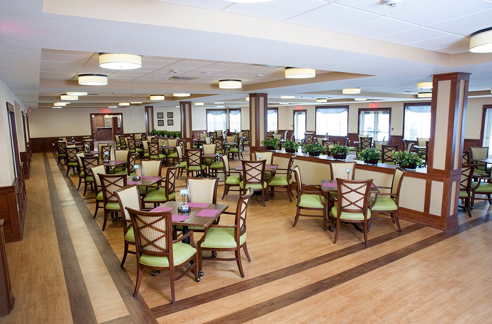 A spacious dining area with neatly arranged tables and chairs.