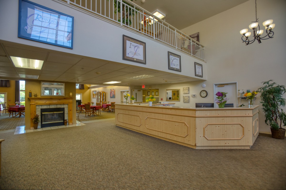 A spacious reception area with a central desk and comfortable seating.