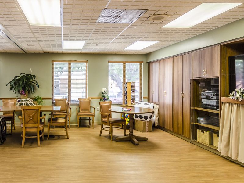 A cozy waiting area with wooden furniture and natural lighting.