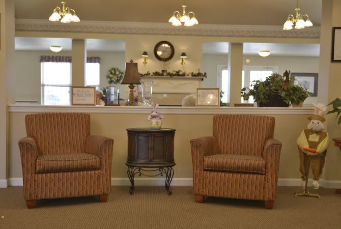 A cozy waiting area with two chairs and a table.
