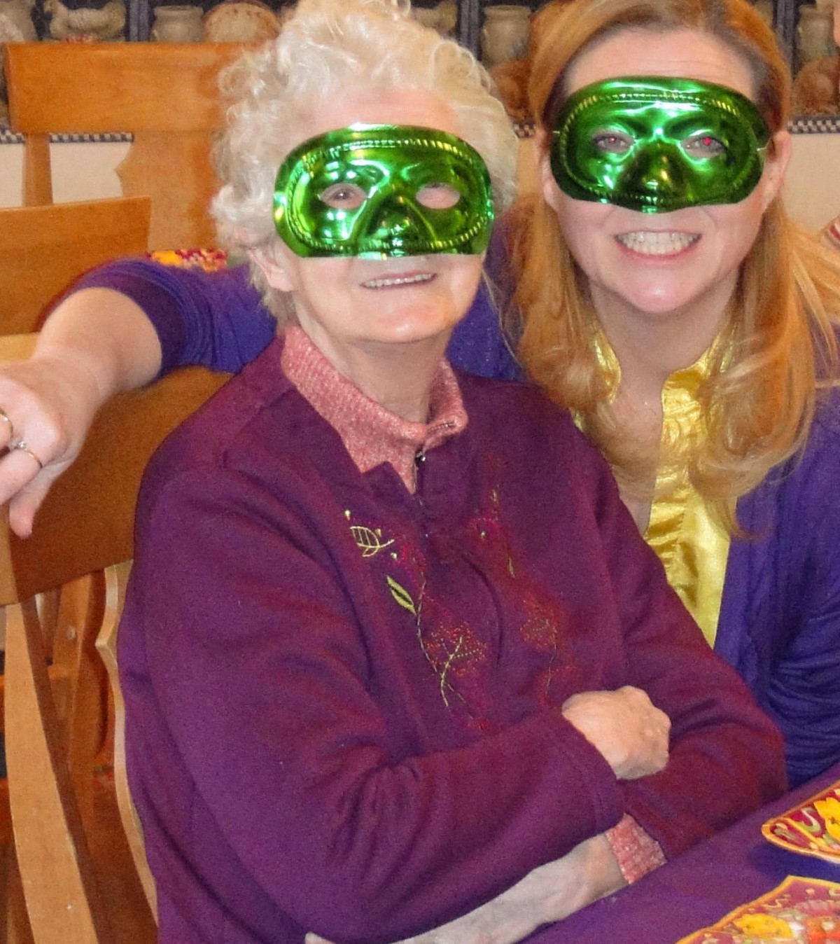 Two people wearing festive green masks at a celebration.