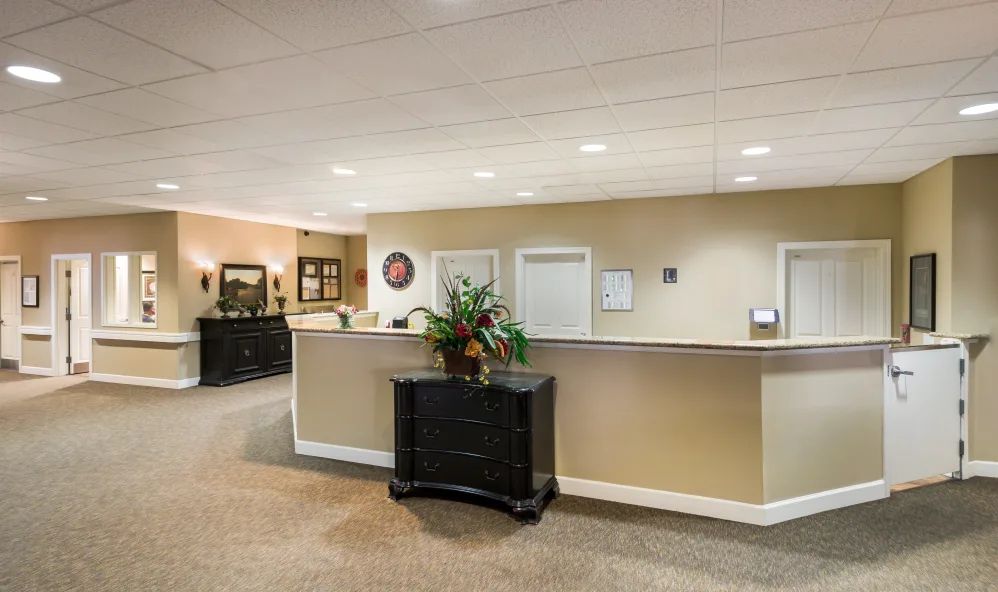 A tidy reception area with a desk and comfortable seating.
