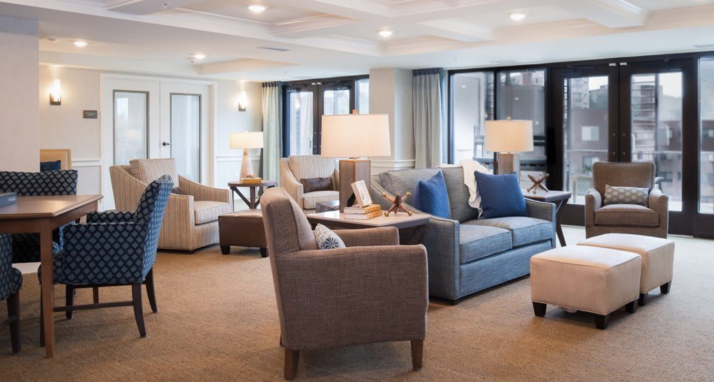 A modern living room with comfortable seating and elegant lighting.