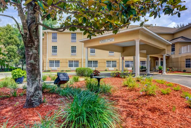 A hotel exterior with well-maintained landscaping and garden.