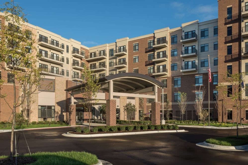 Modern apartment building with a welcoming entrance and landscaped surroundings.