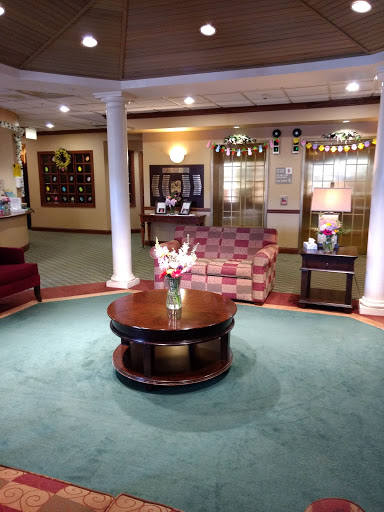 A cozy lobby area featuring comfortable seating, a reception desk, and decorative elements.