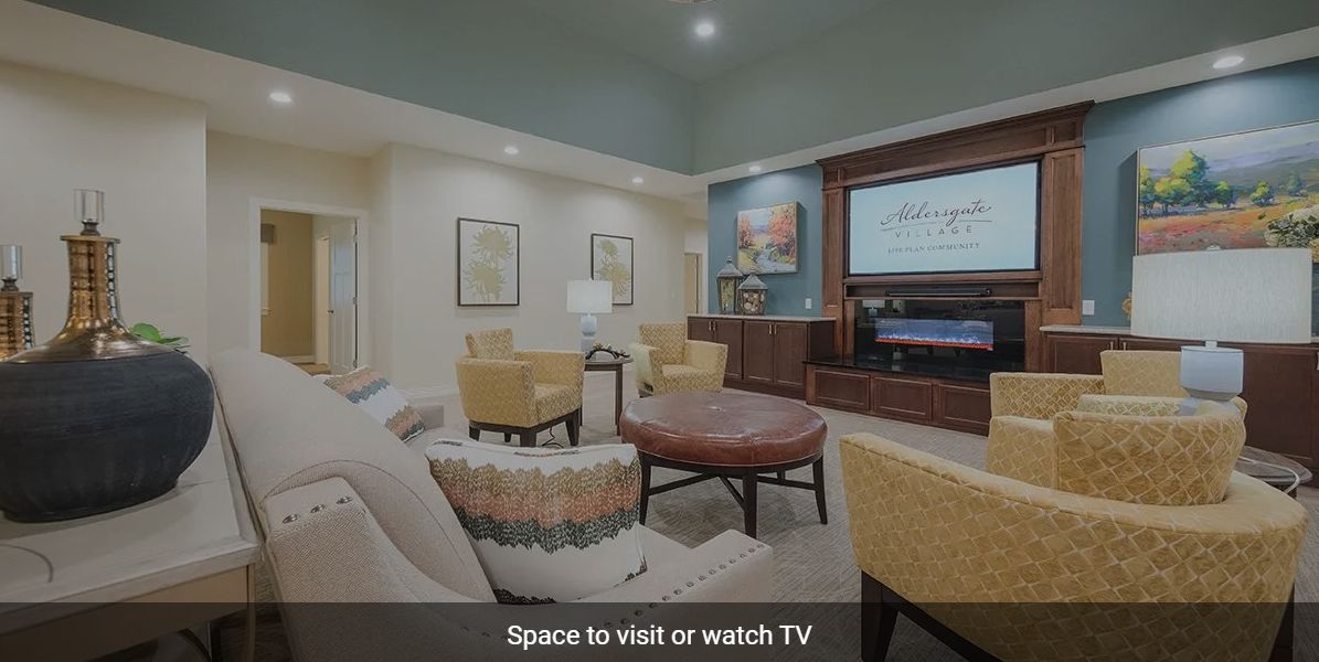 A modern living room with comfortable seating and a large TV.