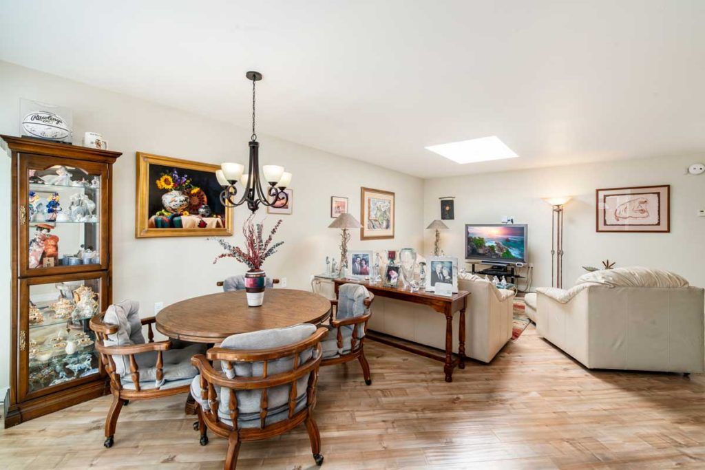 A cozy living and dining area with stylish furniture and elegant artwork.
