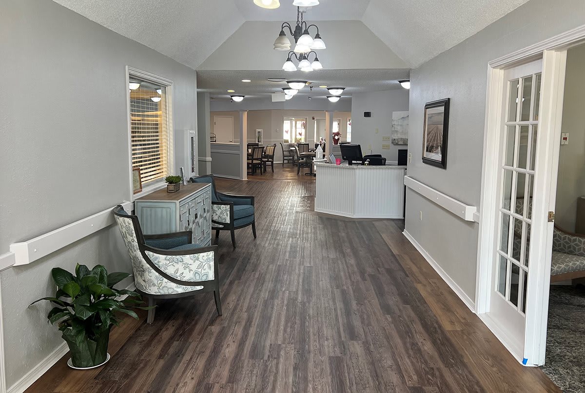 Spacious office reception area with seating and a wooden floor.