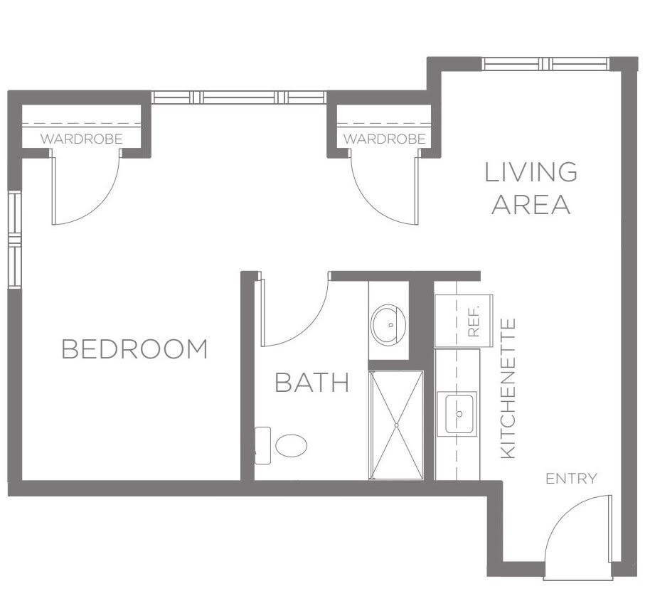 A floor plan of a one-bedroom apartment featuring a living area, bathroom, kitchenette, and entry.