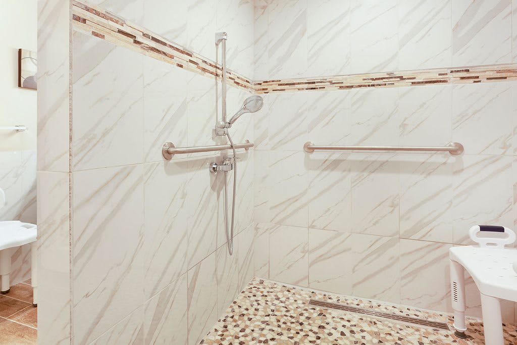 Modern bathroom shower with marble tiles and sleek fixtures.