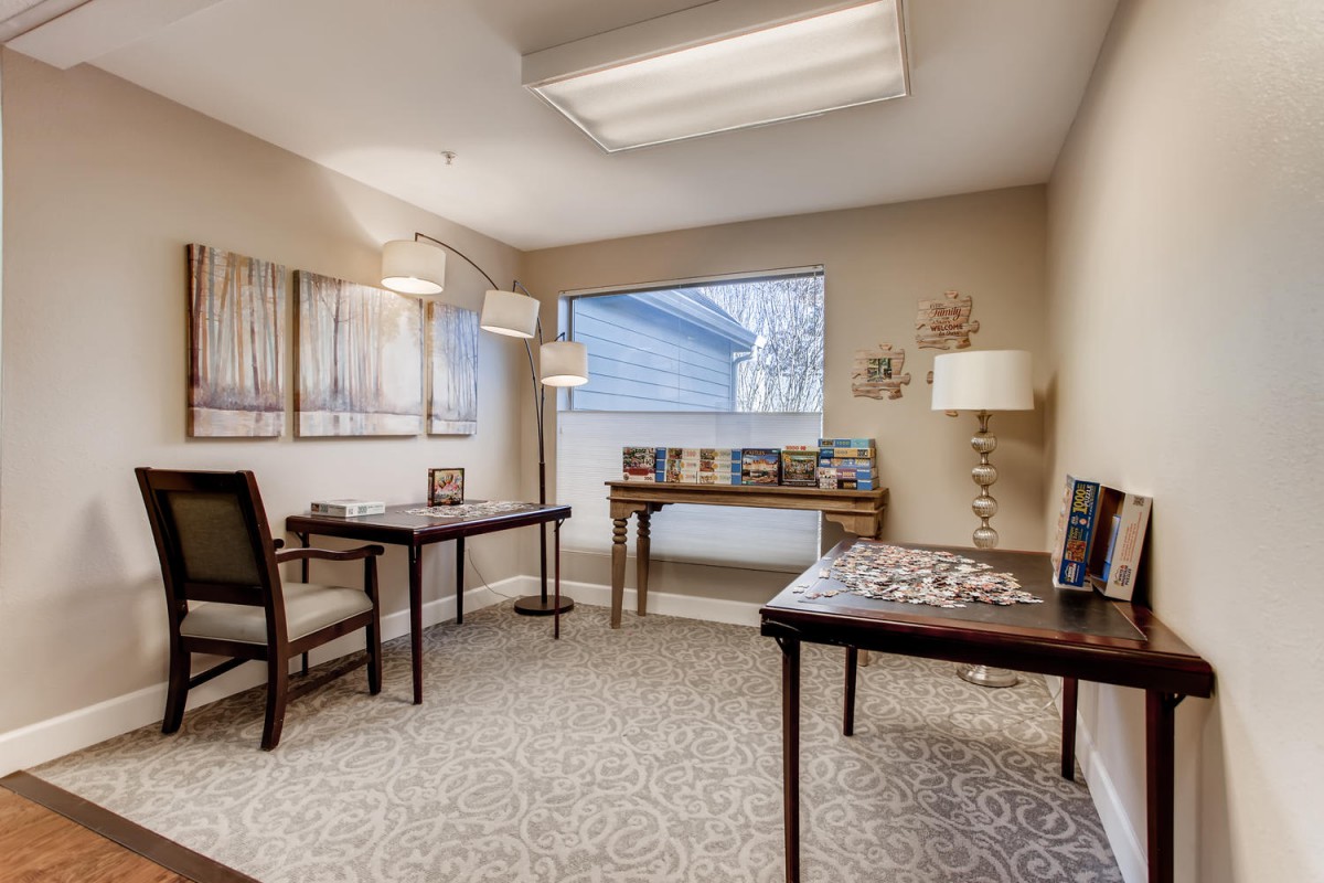 A well-lit office space with several desks, chairs, and decorative elements.