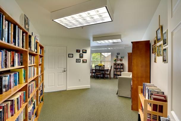 A cozy library interior with bookshelves and a reading area.