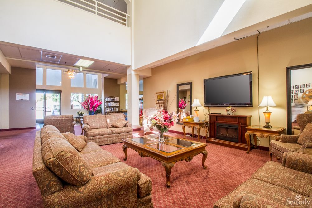 A spacious, well-lit living room with elegant furnishings and decor.