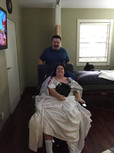 A caregiver assisting a patient in a healthcare setting.