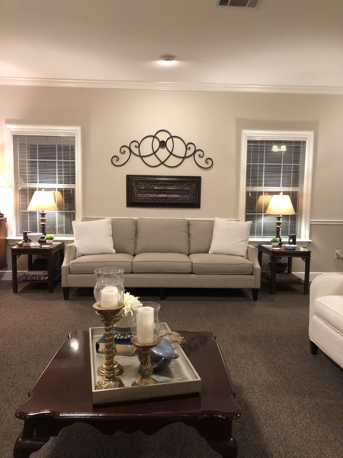 A cozy living room with a neutral-toned sofa, a decorative coffee table, and ambient lighting.