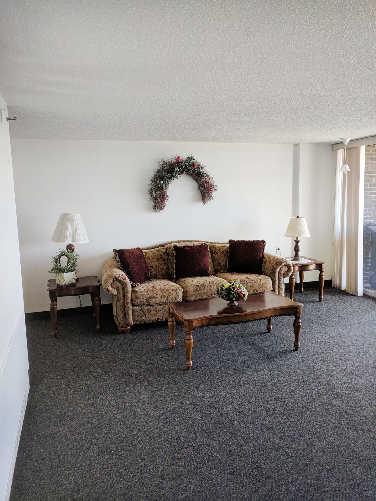 A minimalist living room with a sofa, coffee table, and decorative elements.