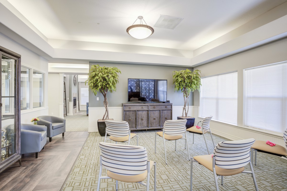 Modern conference room with seating and a television.