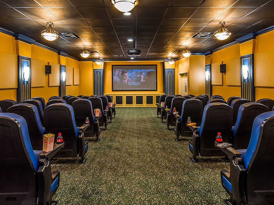 A cozy home theater setup with comfortable seating and a large screen.