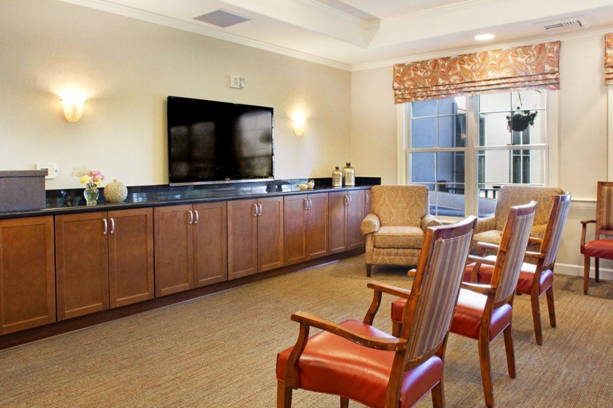 A cozy living room with comfortable chairs and a large television.