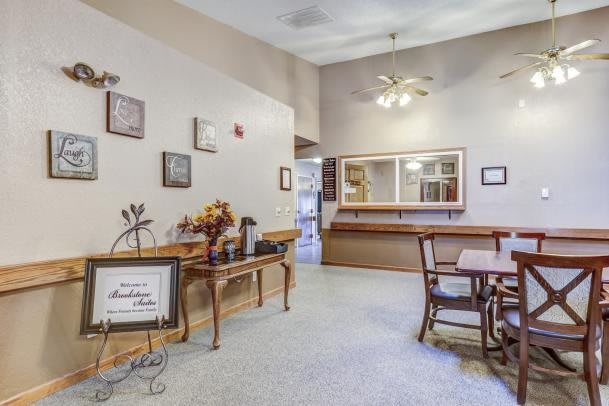 A cozy waiting room with comfortable seating and decorative artwork on the walls.