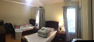 A cozy bedroom with two single beds and soft lighting.