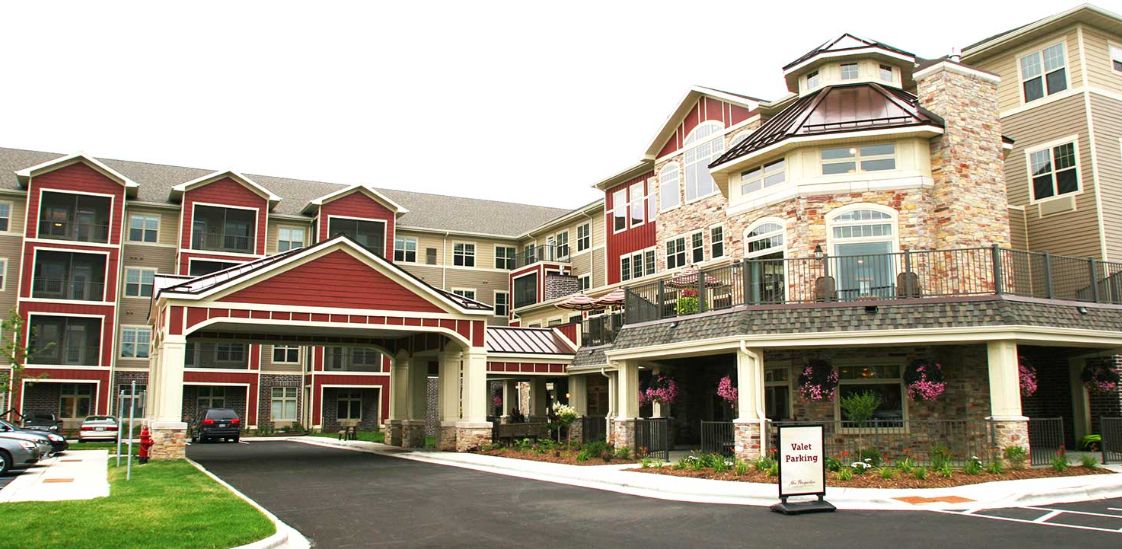 Entrance to a modern residential building with red and beige accents.