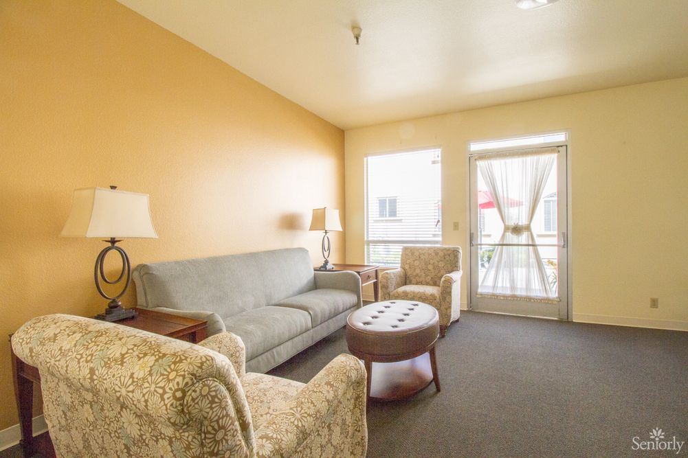 A cozy living room with a sofa, armchairs, and a coffee table.