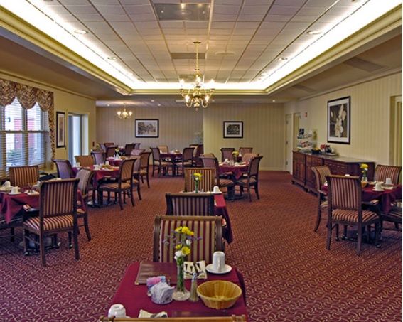Cozy restaurant dining area with neatly arranged tables and elegant lighting.