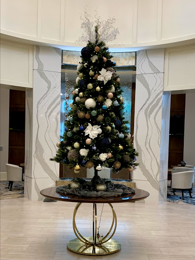 A beautifully decorated Christmas tree in a modern interior setting.