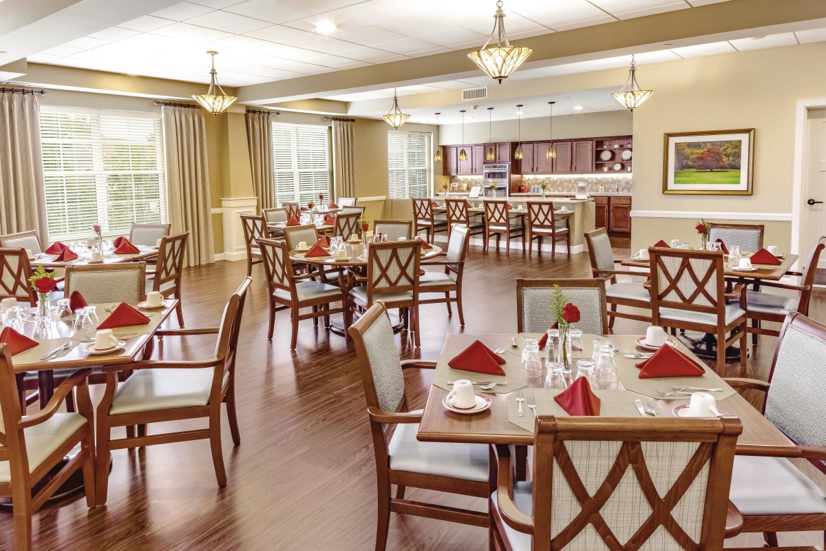 An elegantly decorated dining room with neatly arranged tables and chairs.