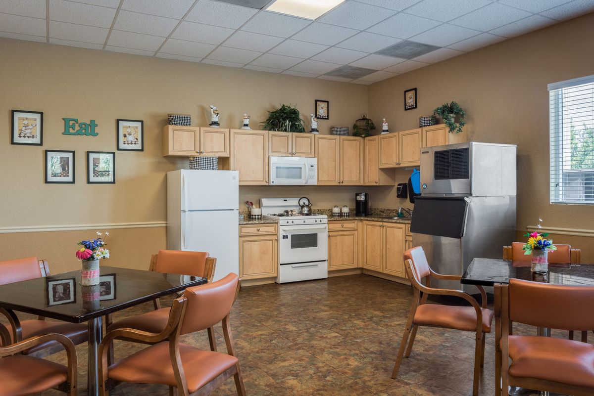 A communal kitchen area with modern appliances and seating.