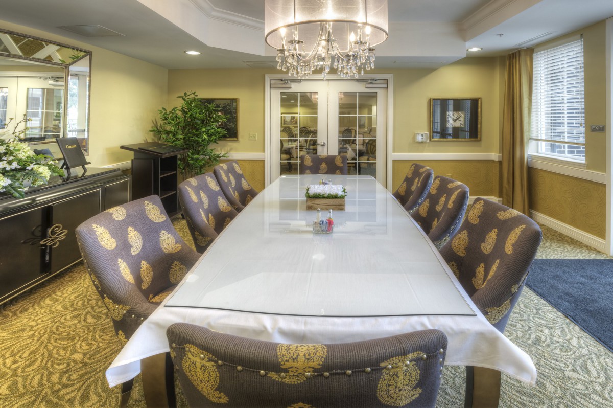 A stylish dining room with an elegant table setting and chandelier.