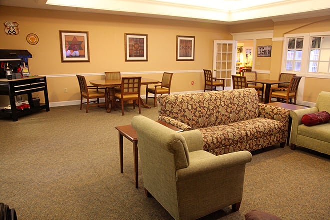 A cozy living room with comfortable seating and warm lighting.