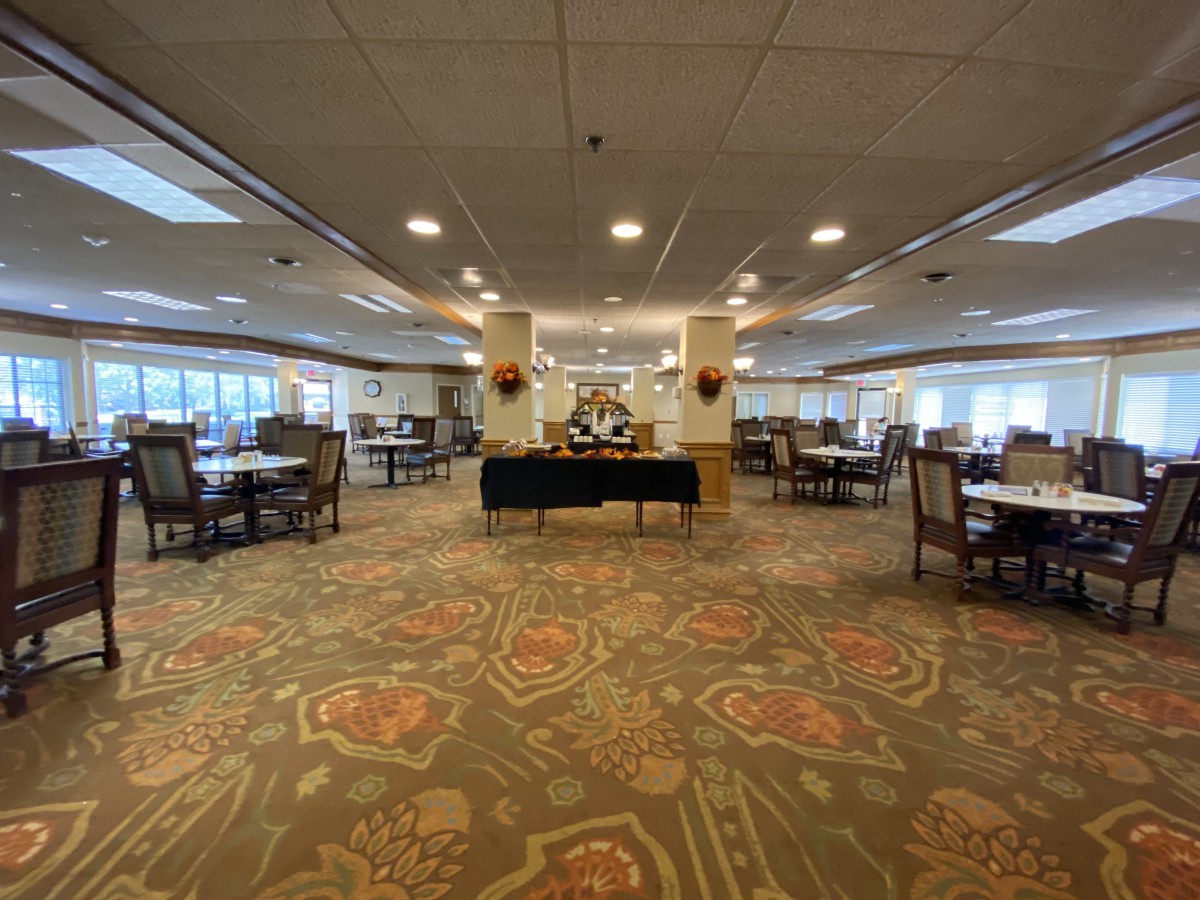 Spacious dining area with a central buffet setup and elegant carpet design.