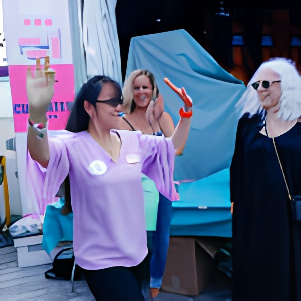 A lively outdoor event with people dancing and enjoying the celebration.