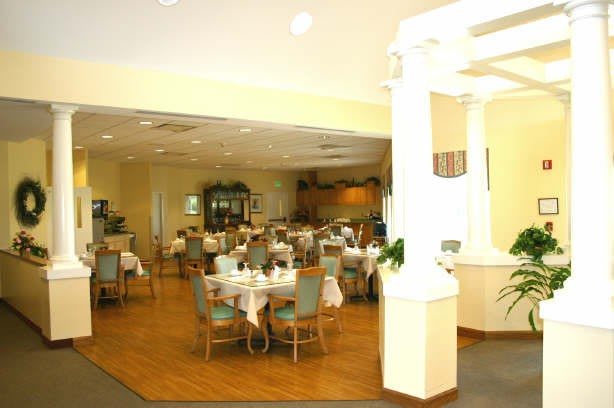 A spacious restaurant dining area with neatly arranged tables and chairs.