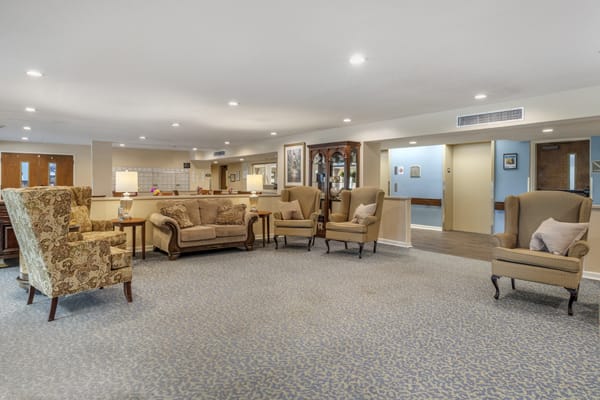 A spacious living room with comfortable seating and warm lighting.