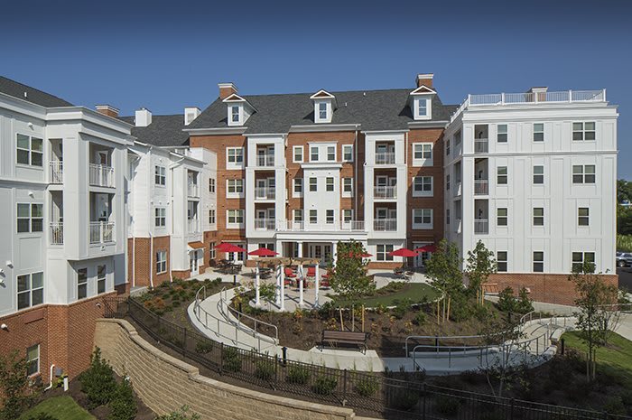 A modern residential apartment building with landscaped gardens.