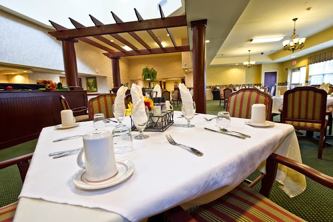 A neatly set dining table in a restaurant interior.
